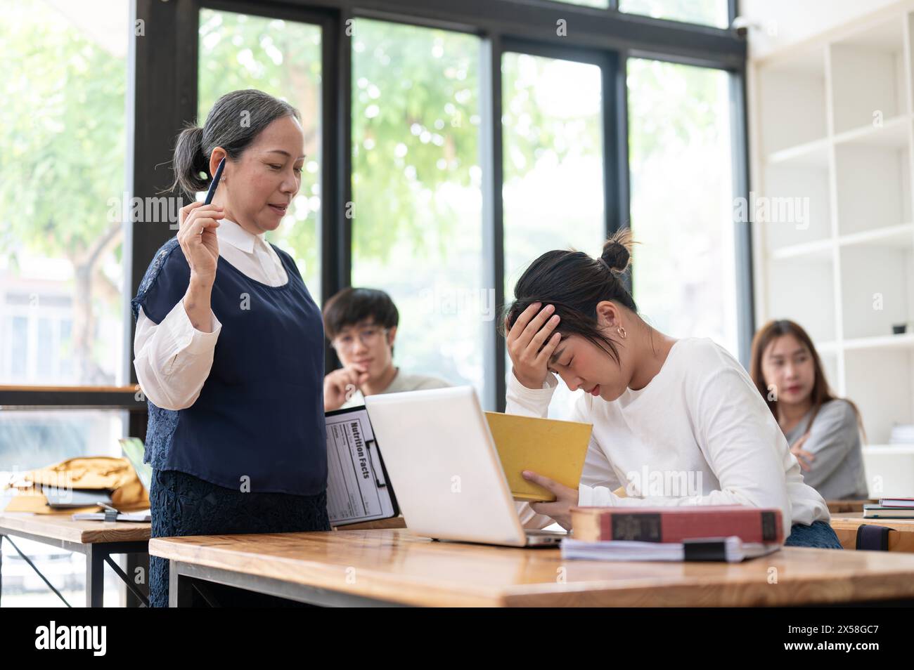 Young student struggle to understand the lesson while teacher trying to ...