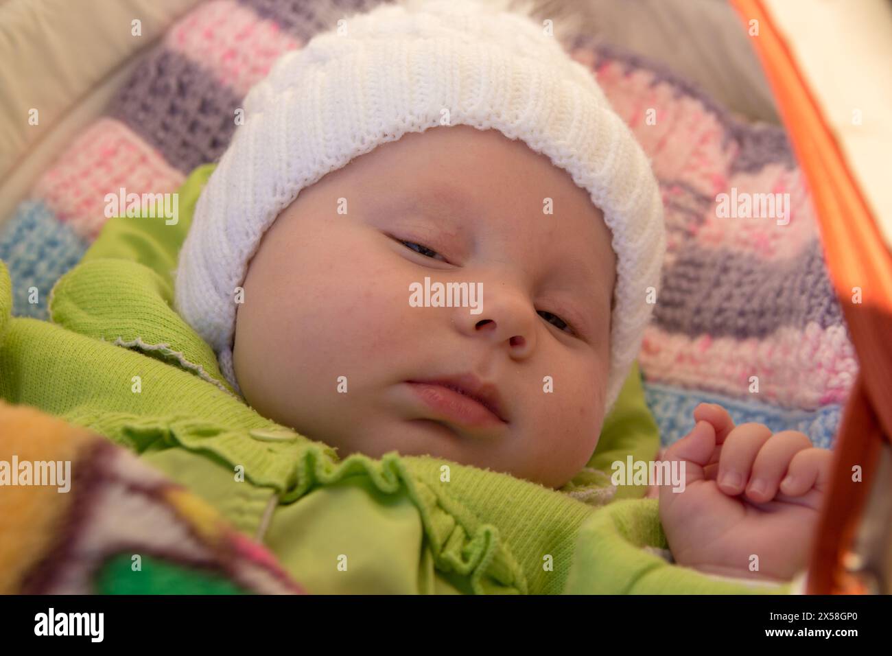 dreaming sweet dream of a newborn baby in a carriage in sunlight Stock Photo