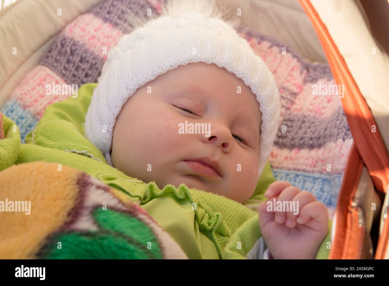 sweet sleeping beautiful baby in a stroller in nature Stock Photo