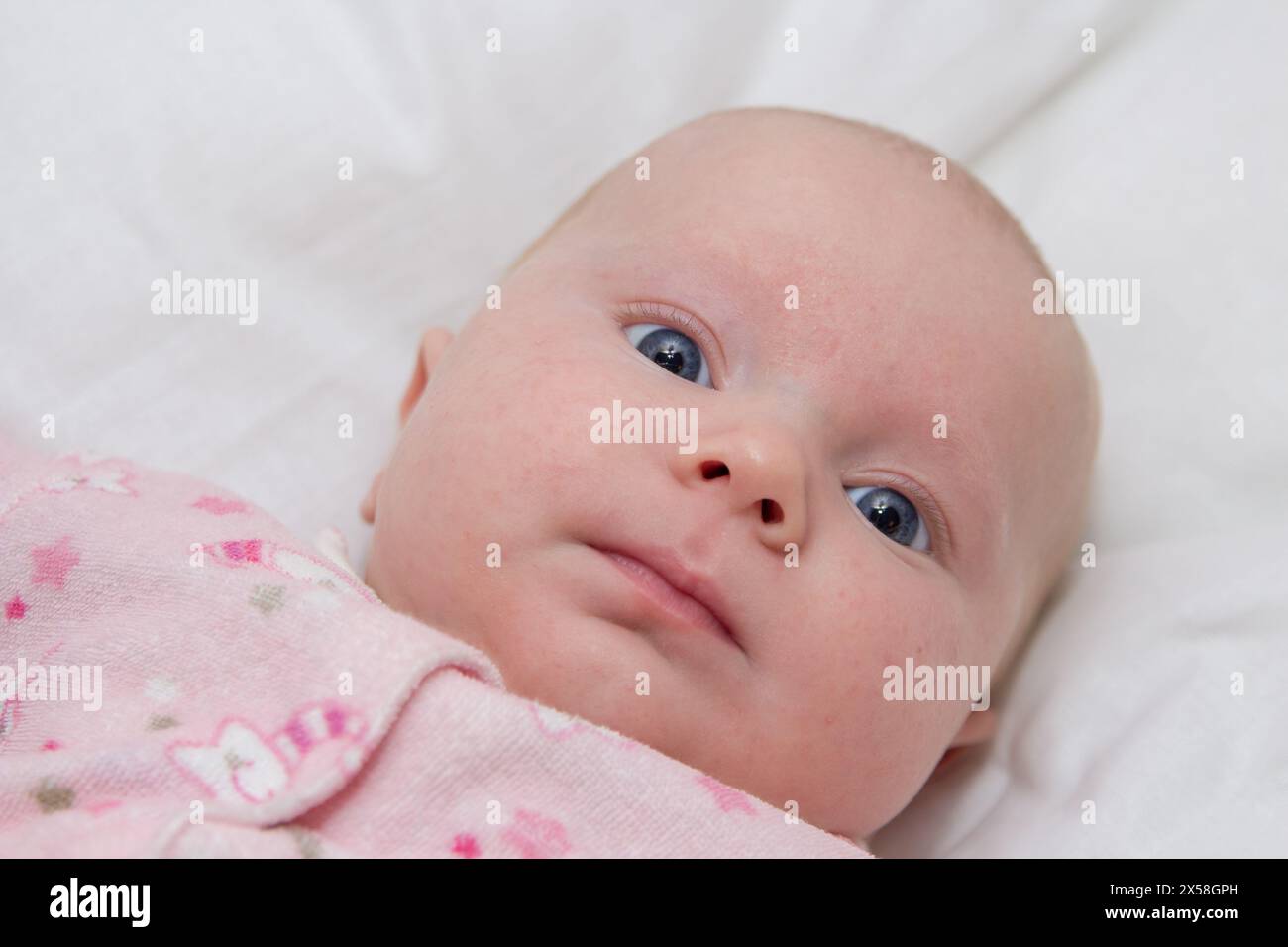 beautiful newborn baby girl with blue eyes with round face Stock Photo