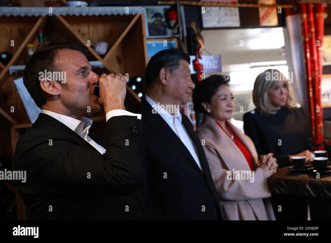 French President Emmanuel Macron, left, drinks coffee in a restaurant with Chinese President Xi Jinping, his wife Peng Liyuan, and Brigitte Macron Tuesday, May 7, 2024 at the Tourmalet pass, in the Pyrenees mountains. French president is hosting China's leader at a remote mountain pass in the Pyrenees for private meetings, after a high-stakes state visit in Paris dominated by trade disputes and Russia's war in Ukraine. French President Emmanuel Macron made a point of inviting Chinese President Xi Jinping to the Tourmalet Pass near the Spanish border, where Macron spent time as a child visiting Stock Photo