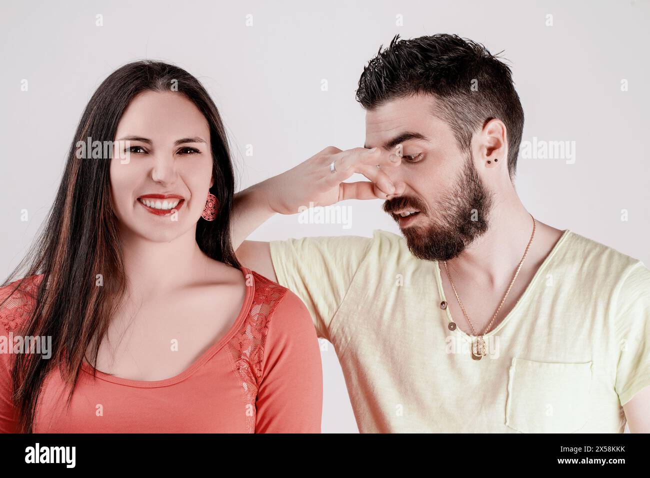 Man and woman in a shouldertoshoulder pose; he looks due to the sweat odor from