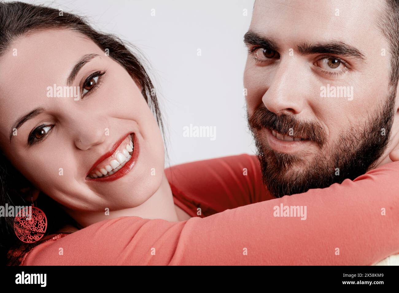 Close interaction between a joyful young woman and a smiling man, both ...