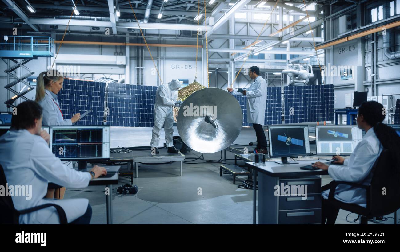 Team of Engineers Working on Satellite Construction. Aerospace Agency Spaceship Manufacturing Factory. Group of Multi-Ethnic Scientists Developing Spacecraft. World Space Exploration Program Stock Photo