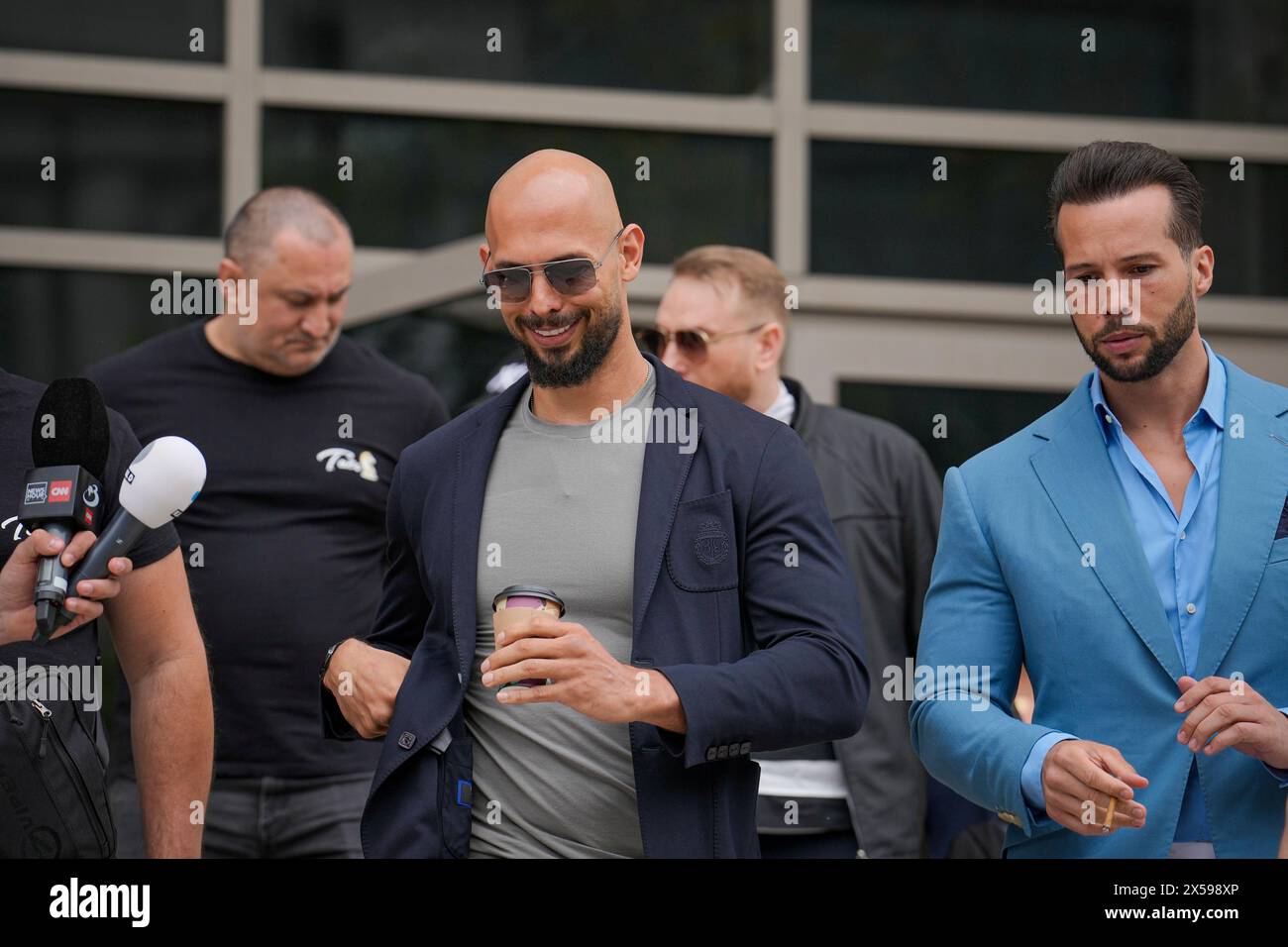 Andrew Tate, center, and his brother Tristan leave the Bucharest Tribunal in Bucharest, Romania, Wednesday, May 8, 2024. A court in Romania's capital ruled on April 26, that a trial could start but did not set a date for the trial to begin in the case of influencer Andrew Tate, who is charged with human trafficking, rape and forming a criminal gang to sexually exploit women. (AP Photo/Vadim Ghirda) Stock Photo