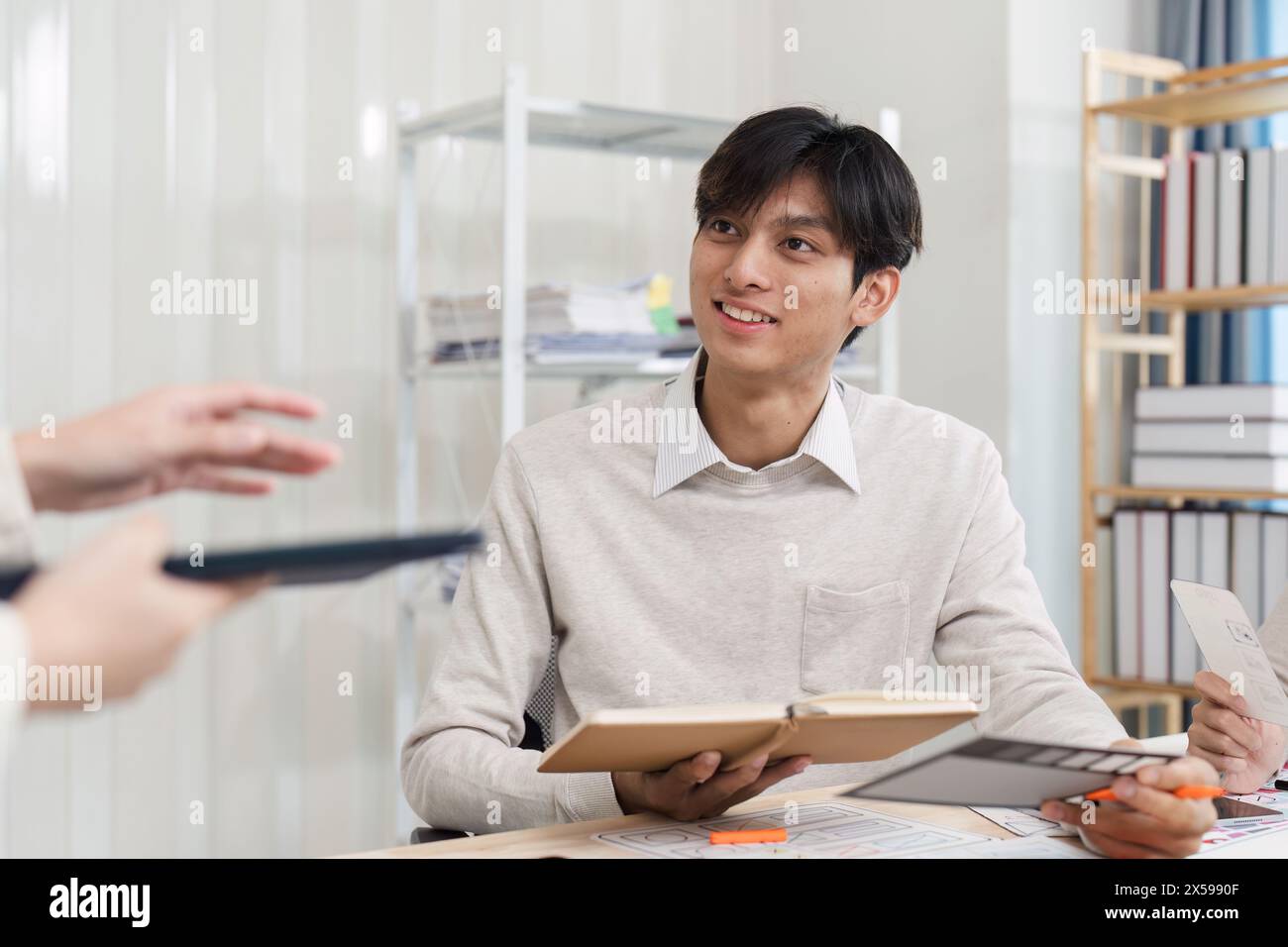 Close up ux developer and ui designer brainstorming interface wireframe design.Creative digital development agency Stock Photo