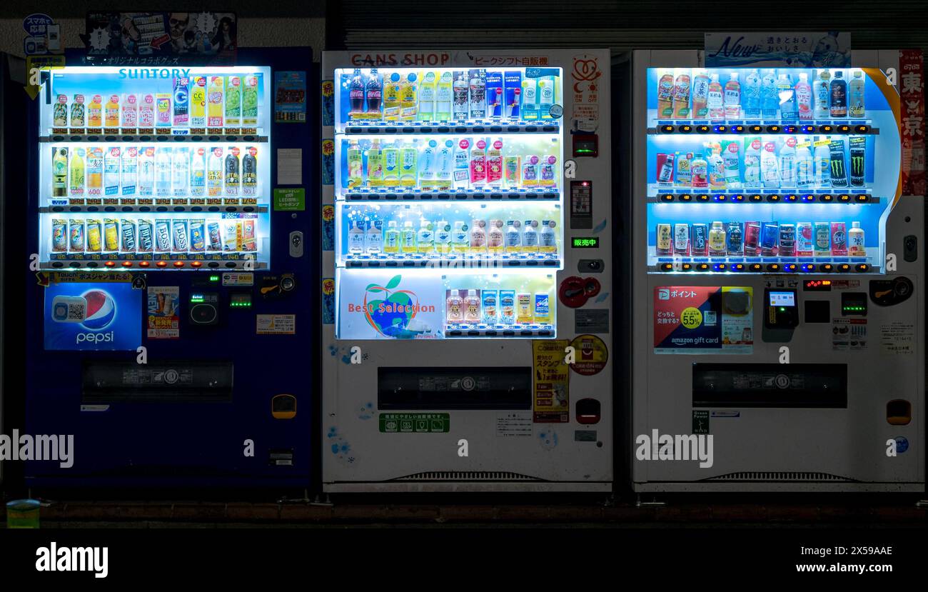 Traditional drink vending machines on a street corner in Tokyo, Japan at night Stock Photo