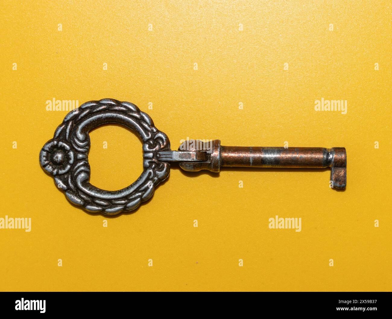 old bookcase key on a colored background, old brass key Stock Photo