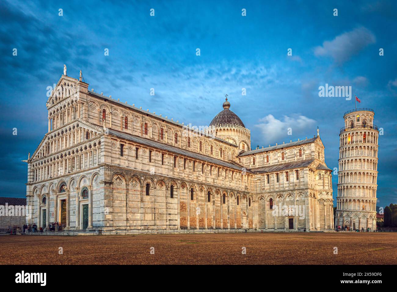 The city of Pisa historic plaza with the Pisa cathedral and the leaning tower illuminated by the blue hour light. Photo taken on 22nd of October 2023 Stock Photo