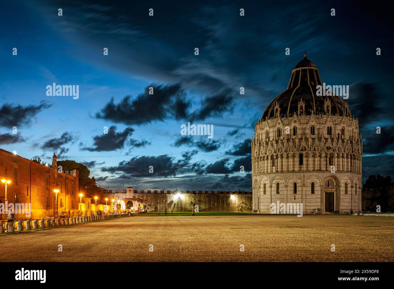 The city of Pisa historic plaza with the Pisa Baptistery against a blue painted stormy sky. Photo taken on 22nd of October 2023 in Pisa, Tuscany regio Stock Photo