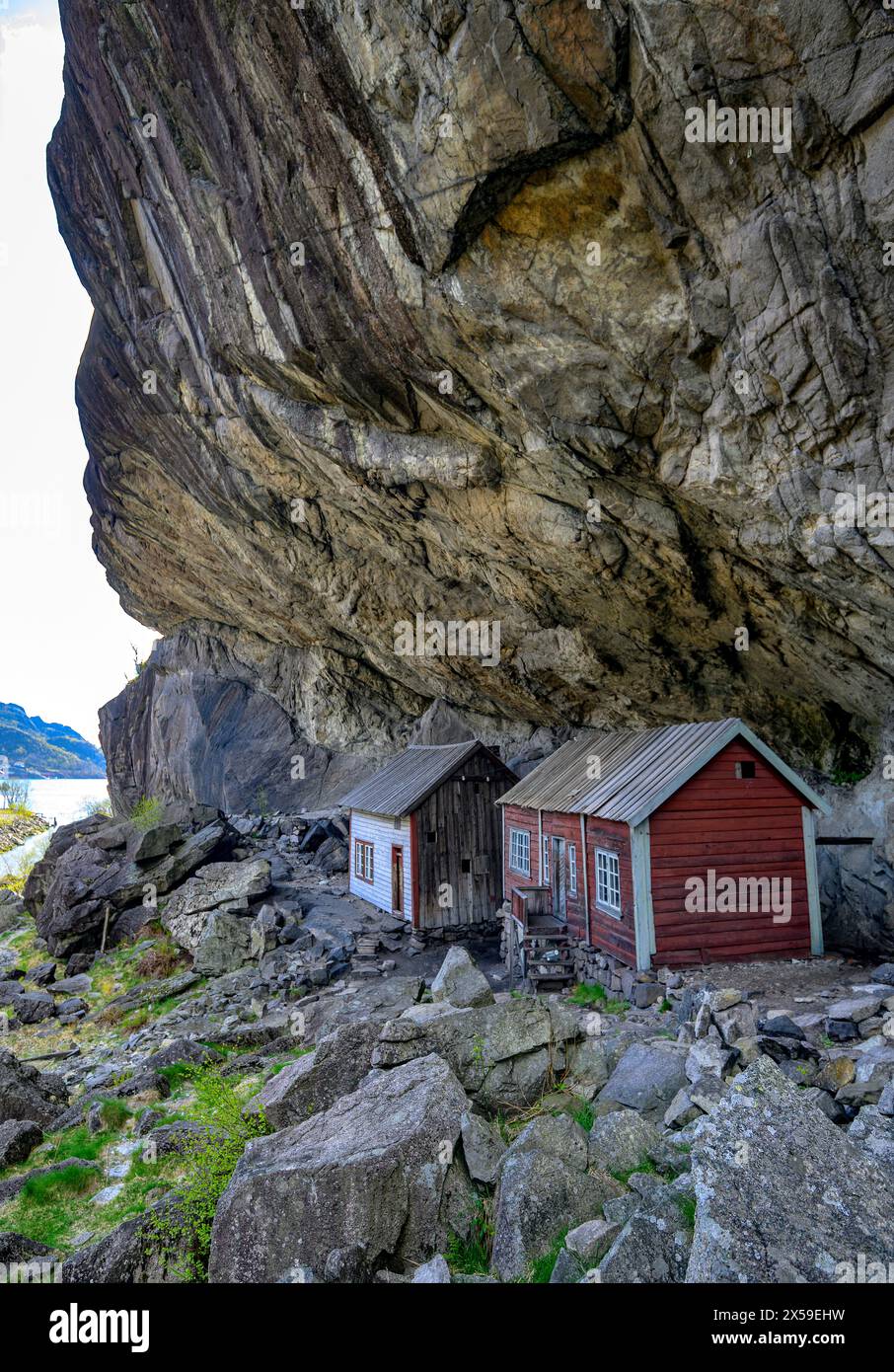 Houses built under a natural rock shelter. Known as 'Helleren' in Jössingfjord (Rogaland) dating back to the 1800s and is a famous historic site in No Stock Photo