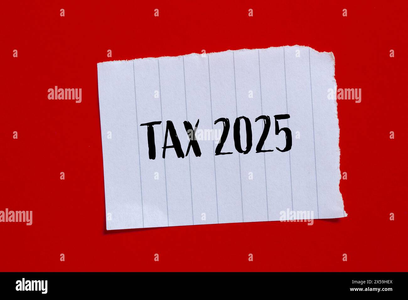 Tax 2025 words written on ripped paper with red background. Conceptual