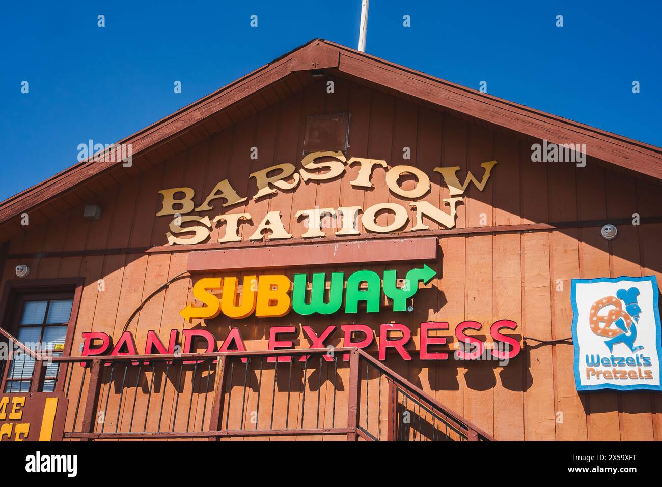 Rustic Building with BARSTOW STATION Sign, Fast Food Logos, Blue Sky
