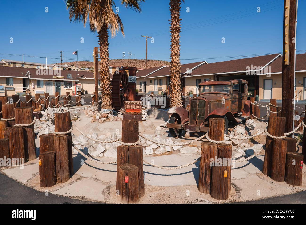 Vintage Americana Rusty Wheel and Palm Trees in Barstow, USA Stock ...