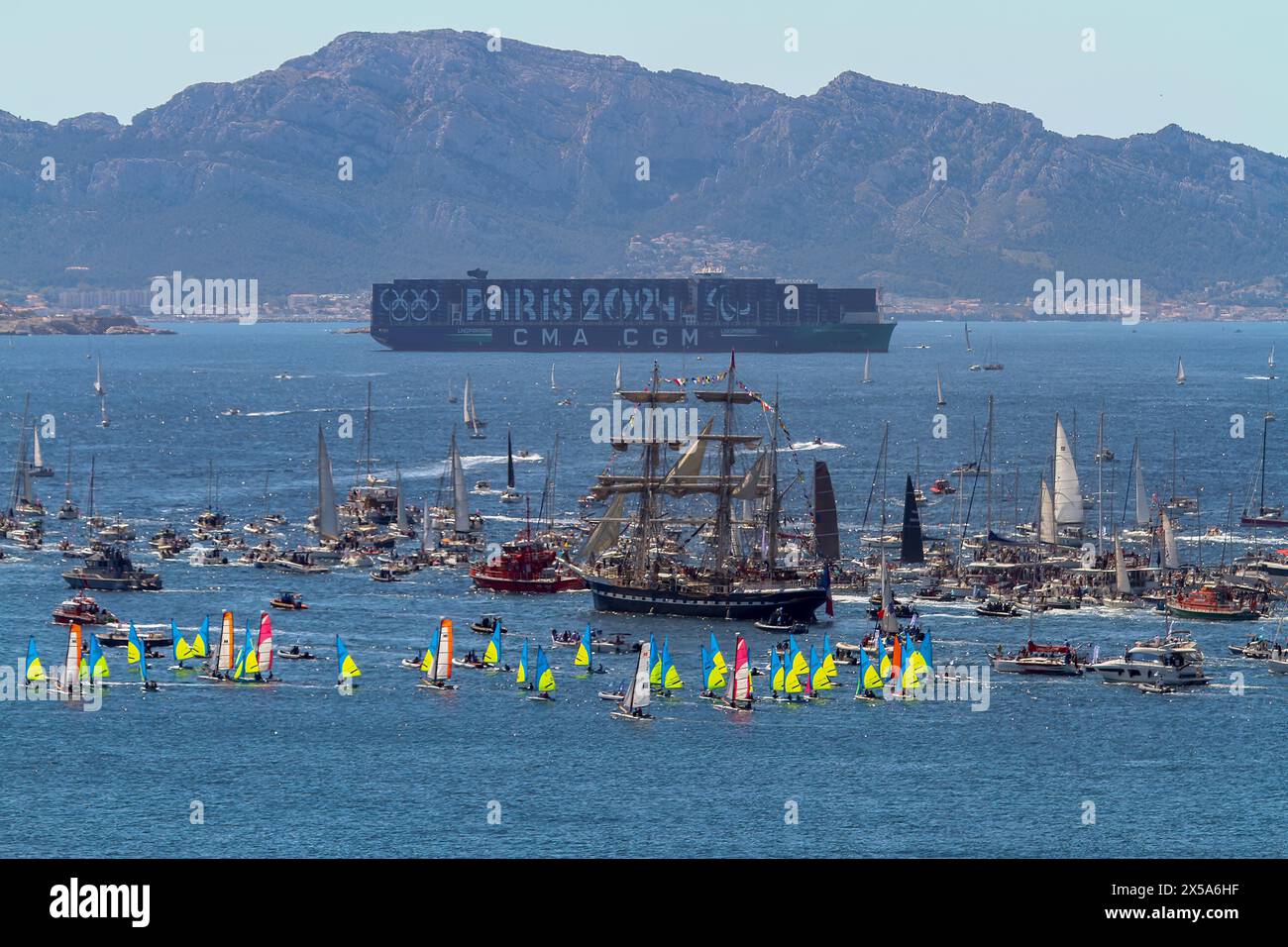 The French three-masted ship “Belem” arrives in Marseille. Coming from Athens with the Olympic flame on board, the Belem arrives in the harbor of Marseille and parades along the coast of the city of Marseille surrounded by thousand of boats. Stock Photo