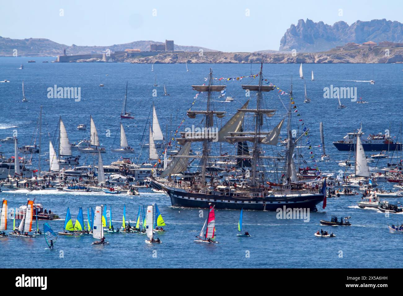 The French three-masted ship “Belem” arrives in Marseille. Coming from Athens with the Olympic flame on board, the Belem arrives in the harbor of Marseille and parades along the coast of the city of Marseille surrounded by thousand of boats. Stock Photo