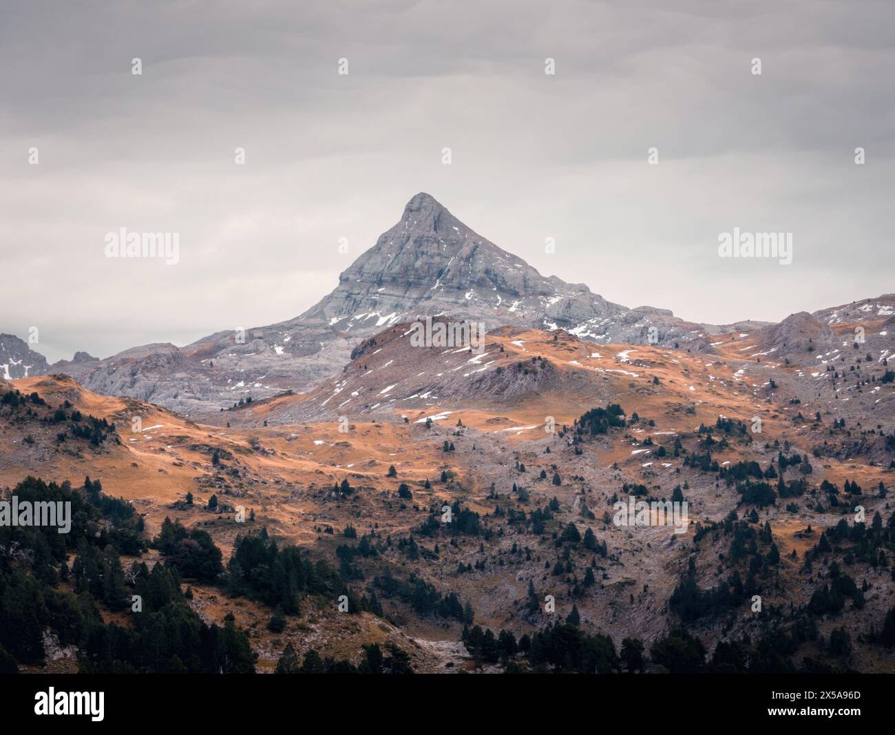 The majestic Pic de Anie stands tall amidst the autumn colored landscape in the Roncal Valley, Pyrenees. Stock Photo