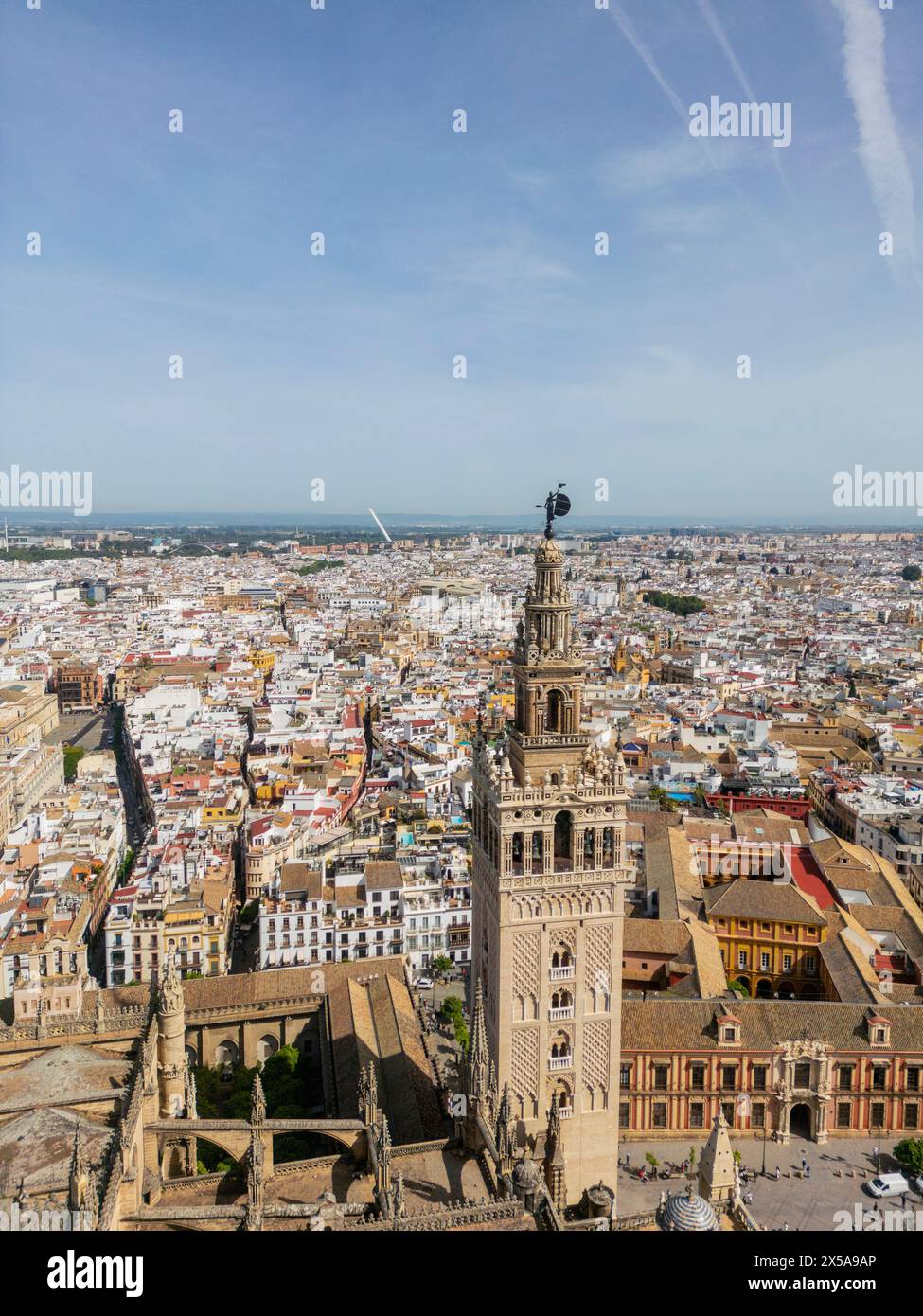 Aerial view of Seville highlighting the iconic cathedral and La Giralda tower with the sculpture that has become a symbol of the city, alongside the M Stock Photo