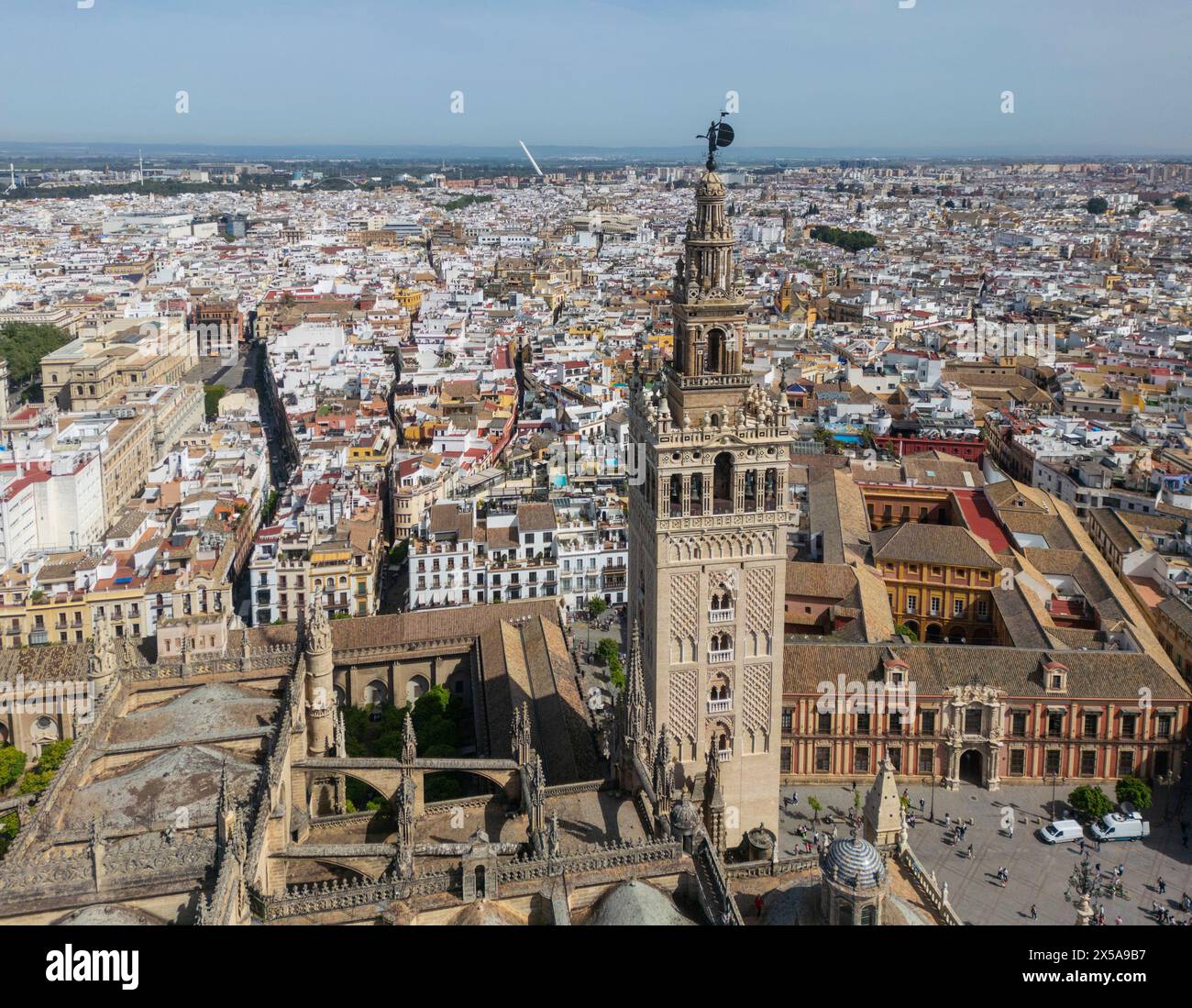 An aerial shot of Seville captures the majestic Cathedral and its iconic bell tower, La Giralda, a symbol of the city since the 16th century, along wi Stock Photo