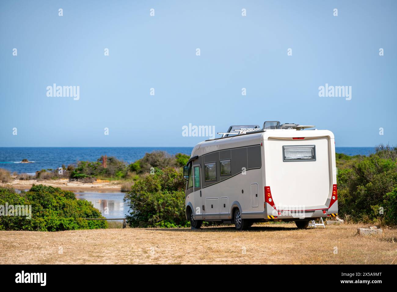 Luxury motorhome parked by the serene coastline of Sardinia, Italy ...