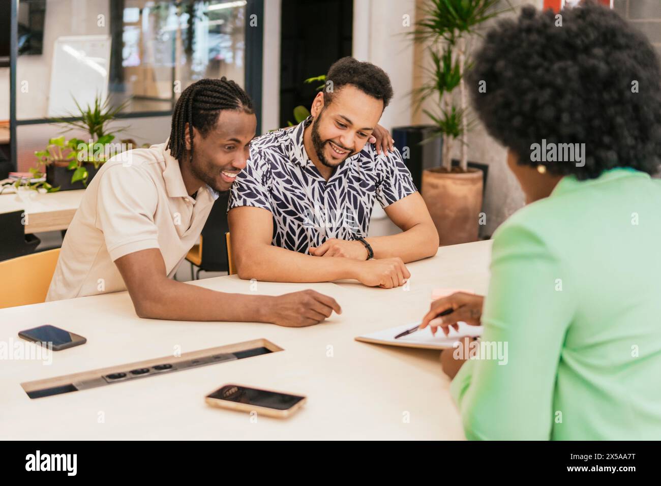 Three young professionals engage hi-res stock photography and images ...
