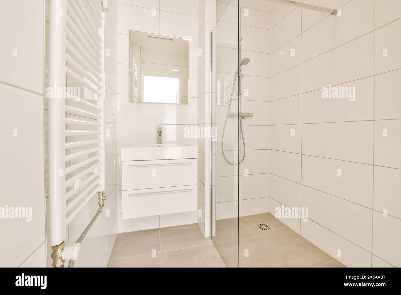 Vanity Over Radiator Contemporary minimalistic bathroom featuring a white vanity, towel ...