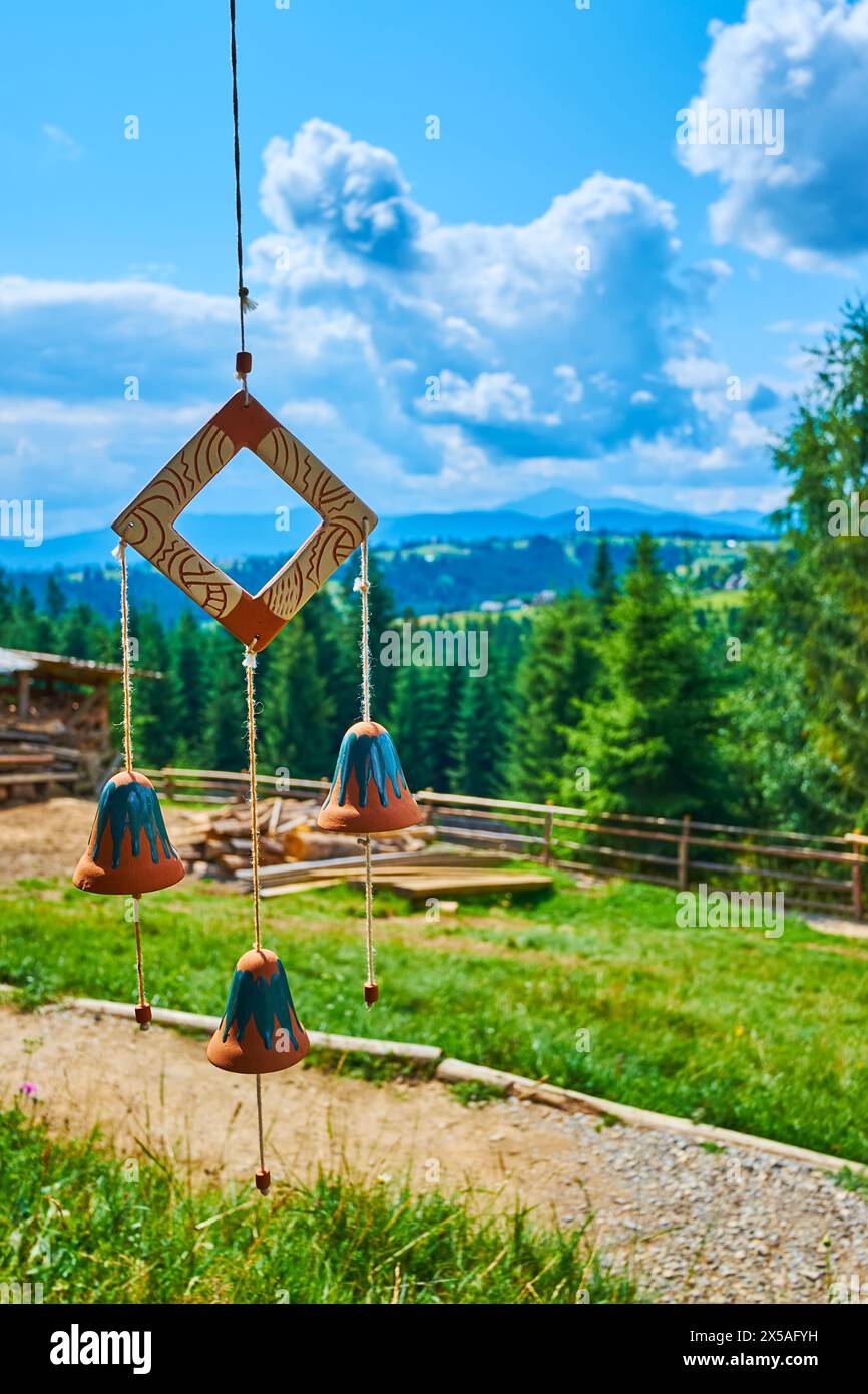 The handmade clay wind chimes against the mountains, Mountain Valley Peppers handicraft village, Ukraine Stock Photo