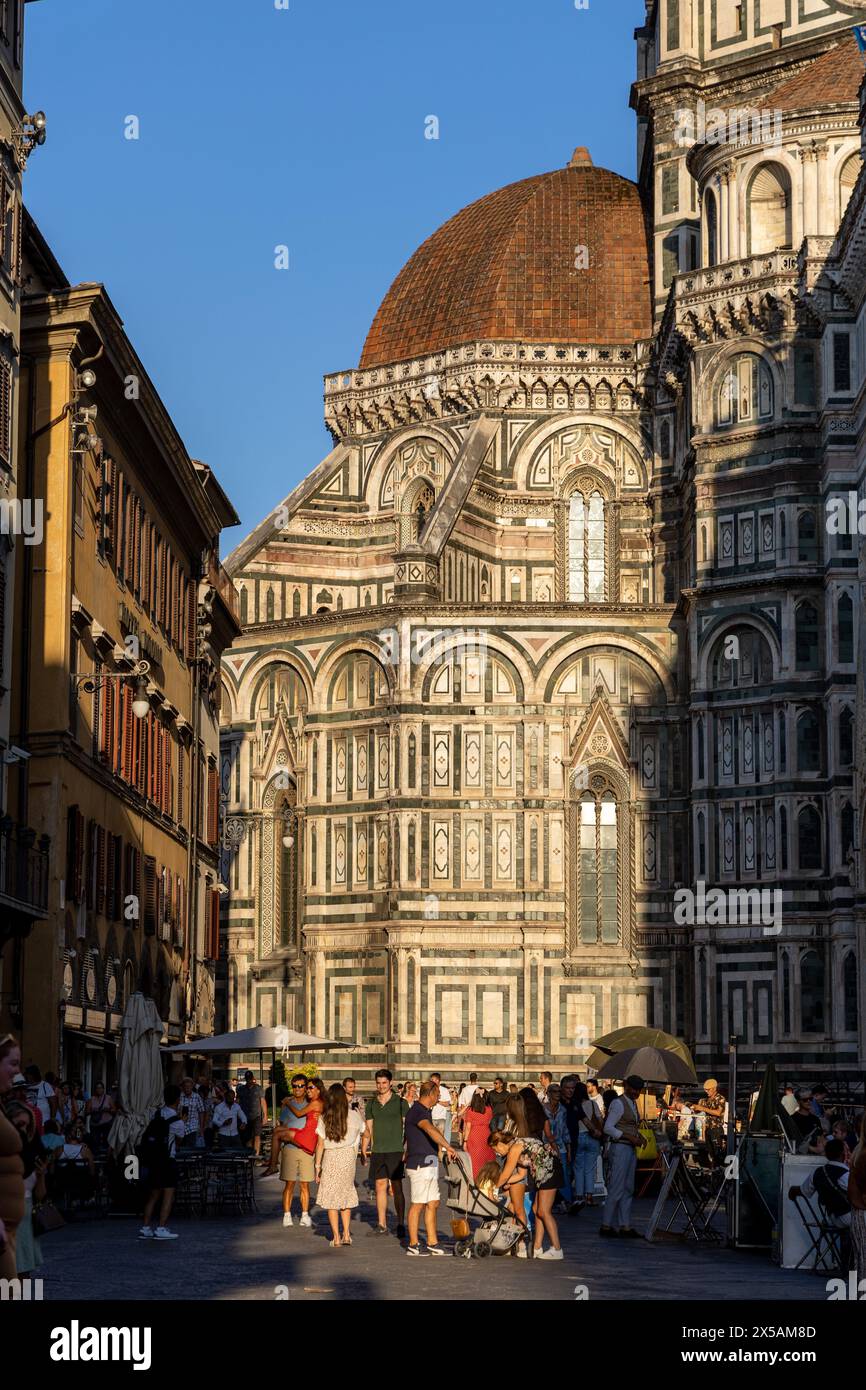 florence,italy - sep 09 2023: Tourists by the cathedral dome in evening sunlight Stock Photo