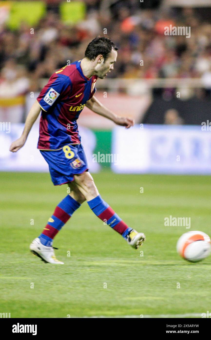 Iniesta in action during a pivotal La Liga match, showcasing skill and focus. Stock Photo