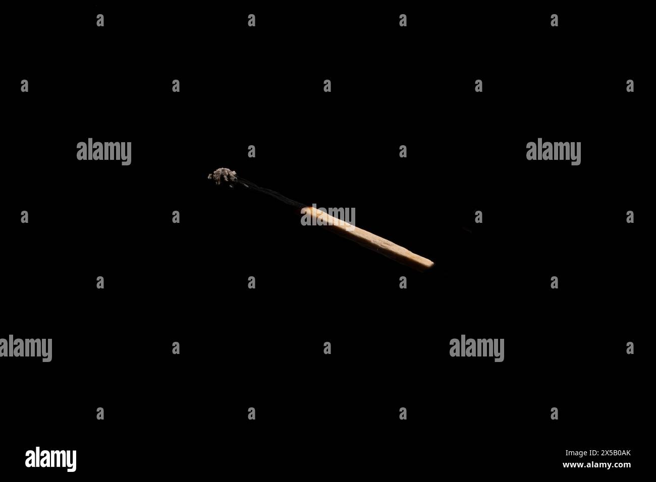 Lit and falling match on a black background. Stock Photo