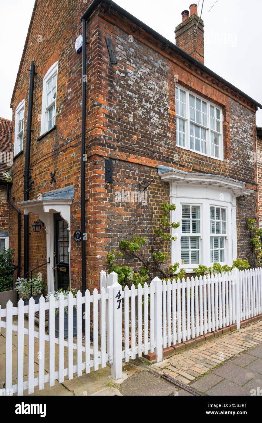 Brick built period house with white picket garden fence High Street old