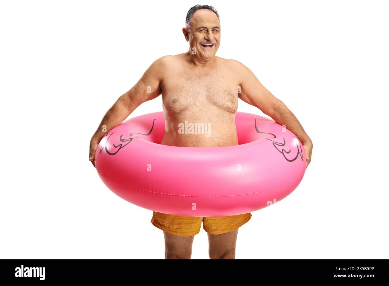 Smiling mature man in swimming shorts with inflatable flamingo rubber ring isolated on white background Stock Photo