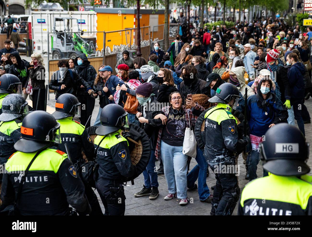 AMSTERDAM - Police officers try to stop demonstrators on the Rokin. In ...