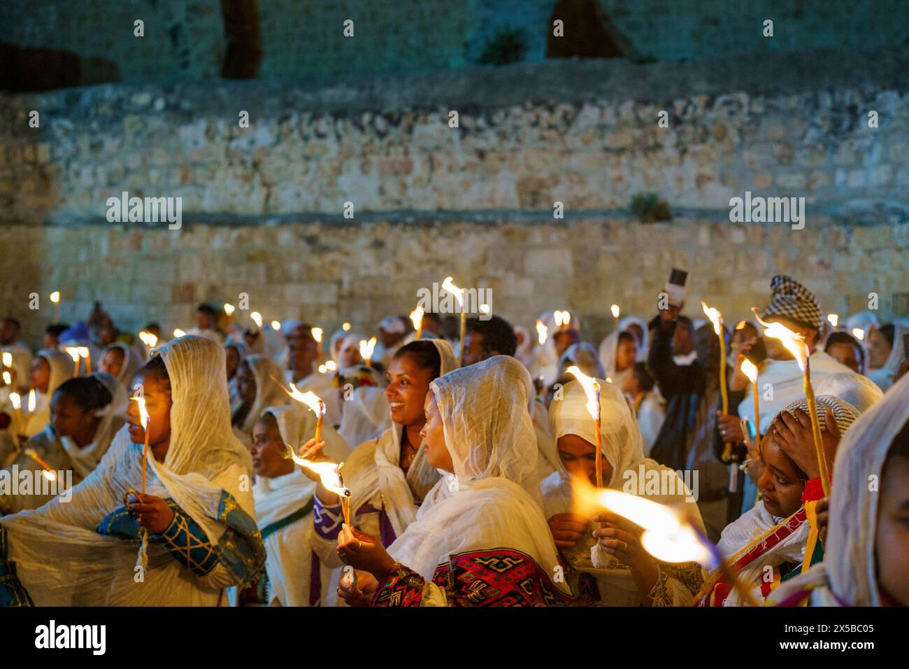 May 4, 2024, Jerusalem, Israel: Participants hold candles during the procession of the Holy Fire Ceremony of the Ethiopian Orthodox Church in Jerusalem. The Holy Fire ceremony is celebrated by orthodox churches in the Church of the Holy Sepulchre in Jerusalem every year before Easter. This spiritual and religious event is one of the most important rituals of the orthodox Christianity, and many pilgrims gather from all around the world to witness it. During the ceremony the Greek Patriarch enters the aediculae where Jesus tomb is located, praying until the holy fire is believed to be lit by the Stock Photo