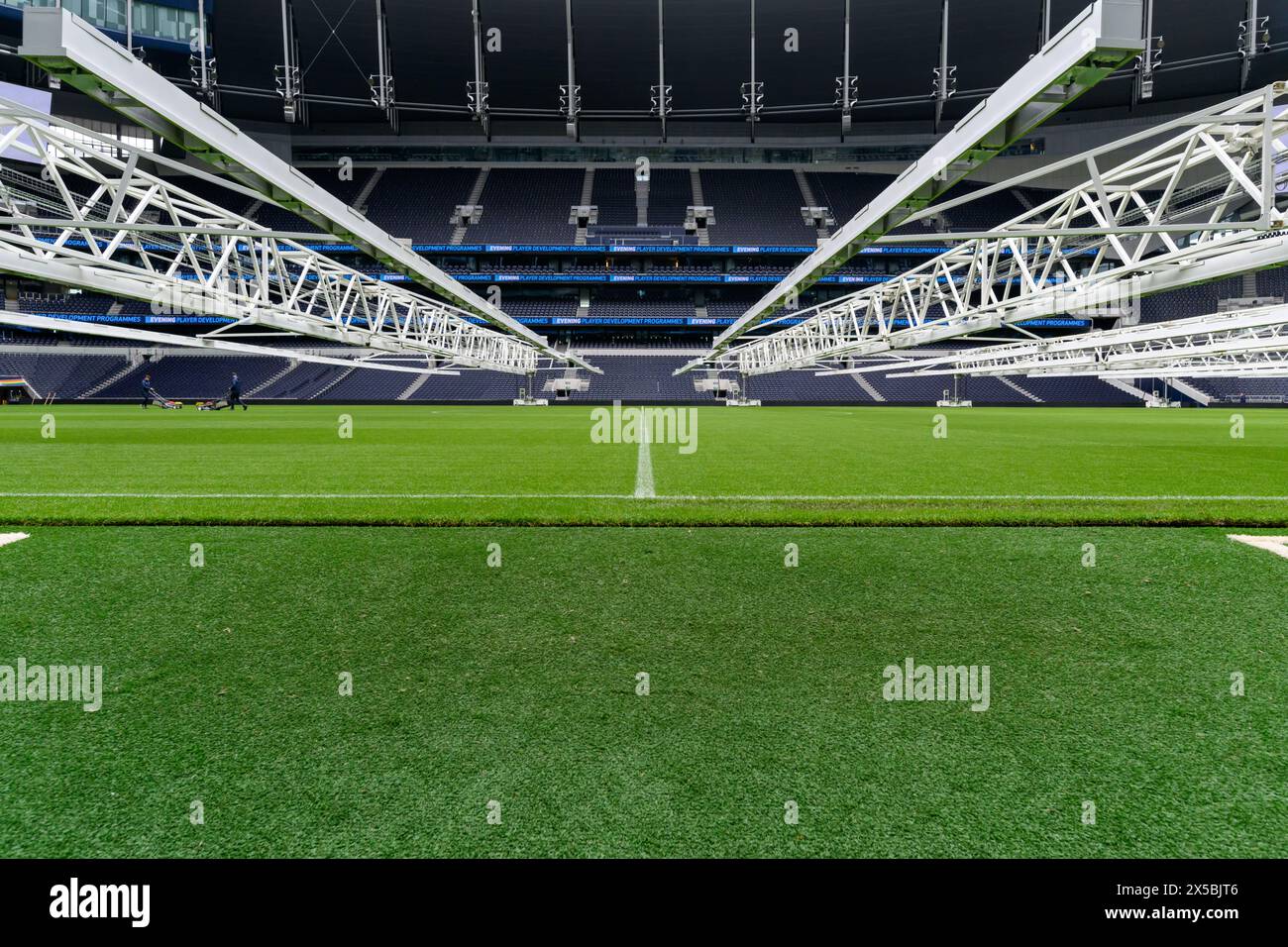 Tottenham Hotspur Football Club Stadium - Pitch Level Photo. View From Players Tunnel With Grass Grow Lighting Stock Photo