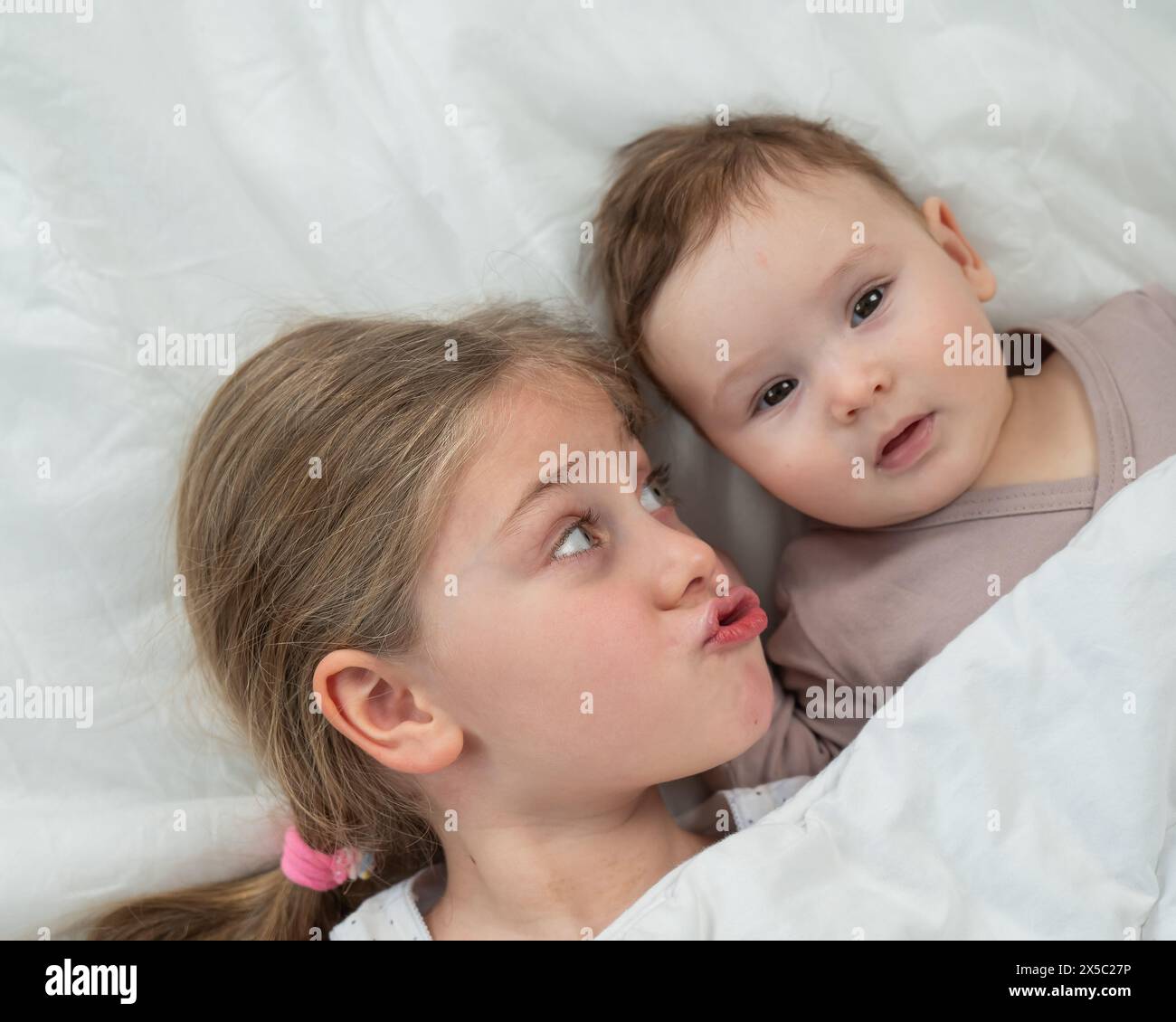 top-view-of-a-little-boy-and-his-six-year-old-sister-lying-under-a