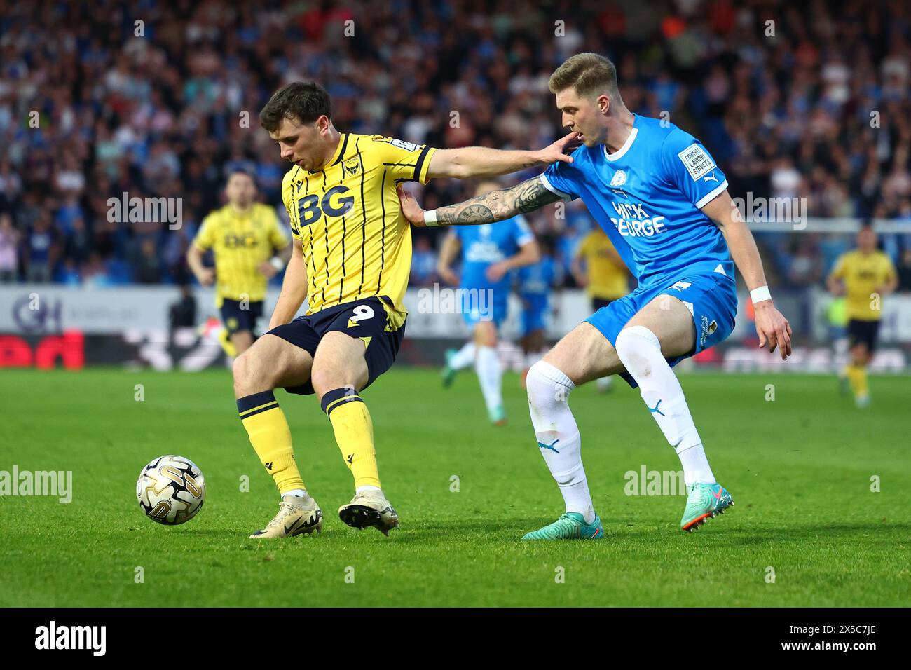 8th May 2024; Weston Homes Stadium, Peterborough, Cambridgeshire, England; League One Play Off Semi Final, Second Leg Football, Peterborough United versus Oxford United; Mark Harris of Oxford United is under pressure from Josh Knight of Peterborough United Stock Photo