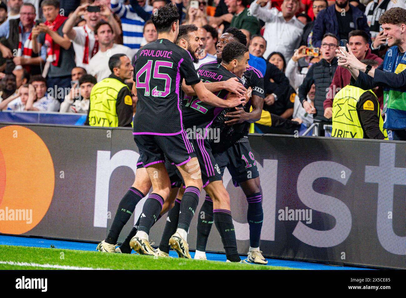 Madrid, Madrid, Spain. 8th May, 2024. MADRID, SPAIN - MAY 8: Alphonso Davies of FC Bayern Munchen (R) seen celebrating his goal with Jamal Mus'tala (C) and Aleksandar Pavlovic (L) during the UEFA Champions League semi-final second leg match between Real Madrid and FC Bayern Munchen at Estadio Santiago Bernabeu on May 8, 2024 in Madrid, Spain. (Credit Image: © Alberto Gardin/ZUMA Press Wire) EDITORIAL USAGE ONLY! Not for Commercial USAGE! Stock Photo