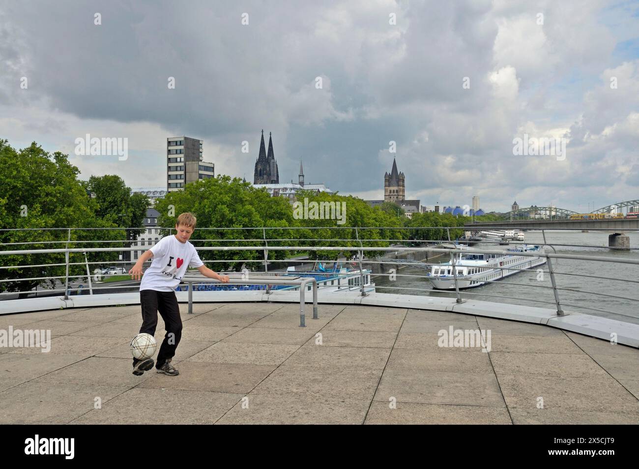 A tenyearold boy playing with his football, viewing platform of the