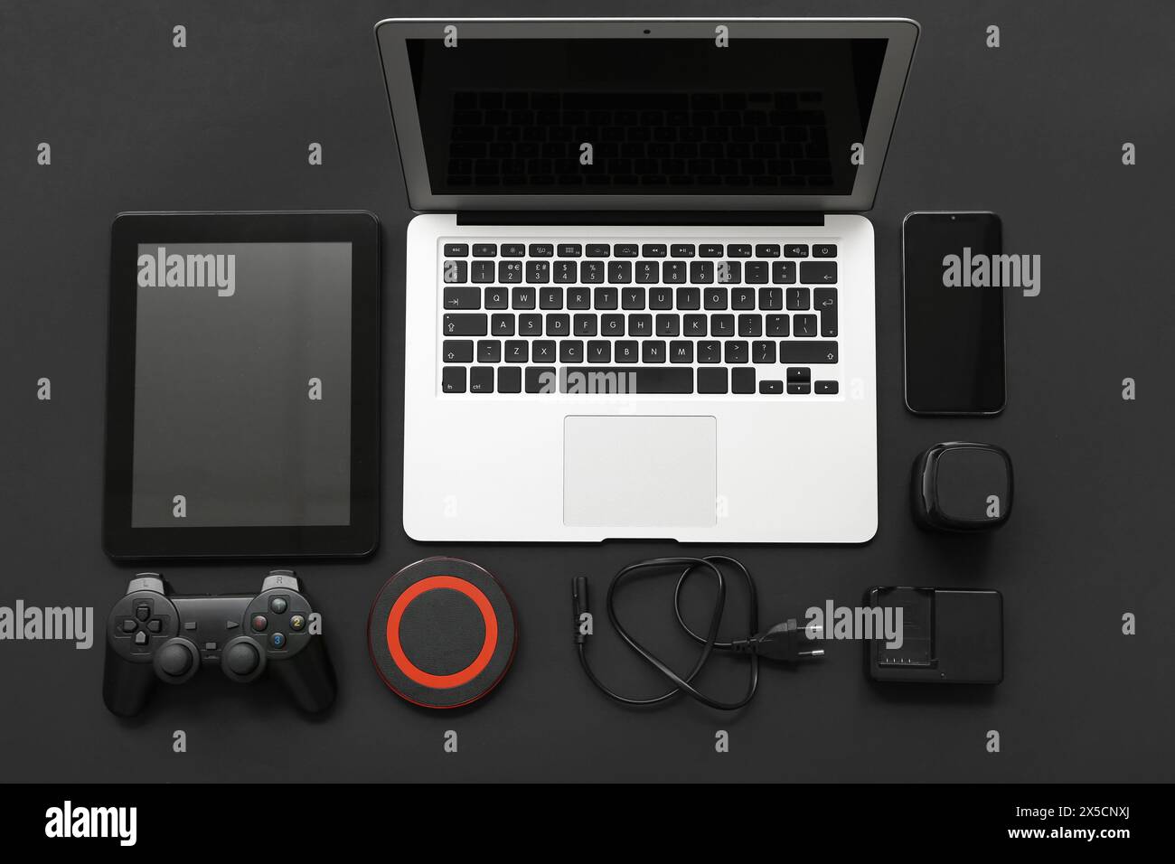 Composition with different modern gadgets on dark background Stock Photo