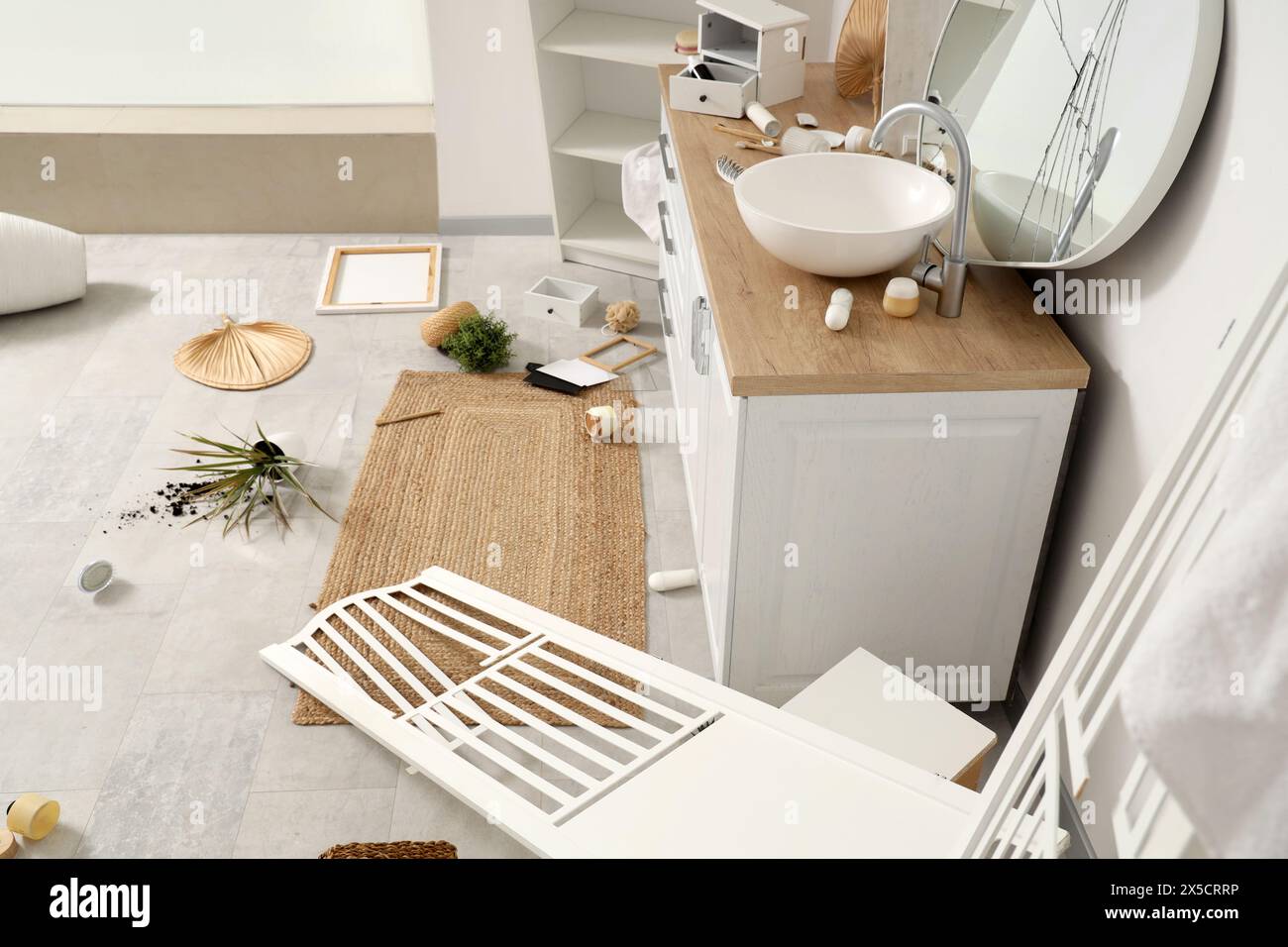 Counters with overturned things on floor in messy bathroom Stock Photo