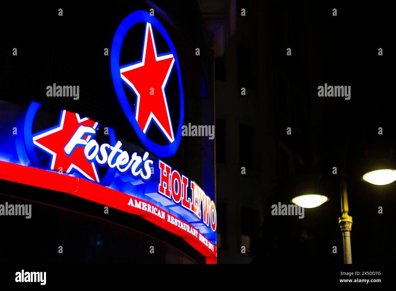 Valencia, Spain. January, 23, 2023 - Sign and logo of the Foster's Hollywood fast food restaurant in Valencia. night photo Stock Photo