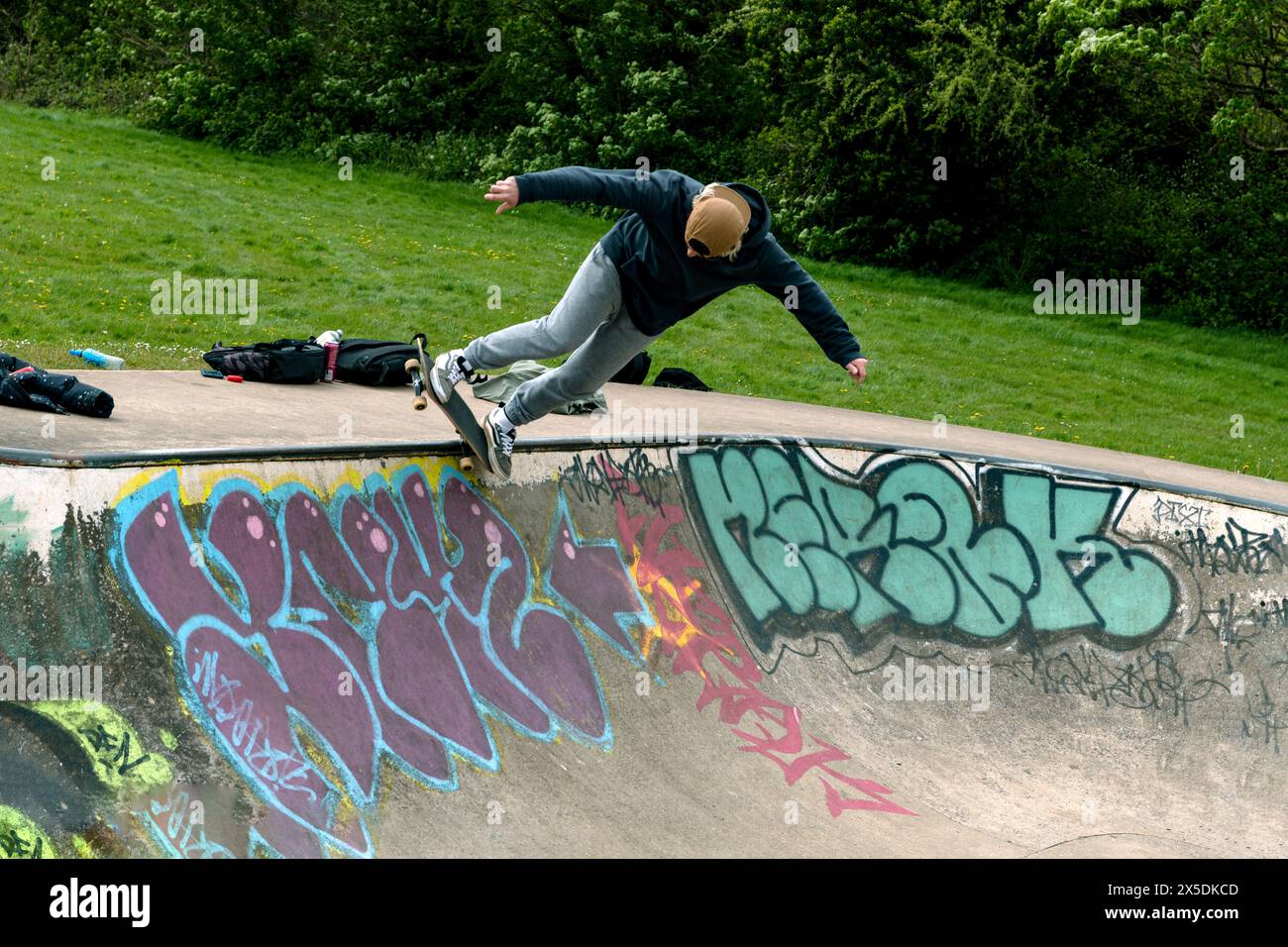 Youth does tricks on a skateboard Stock Photo