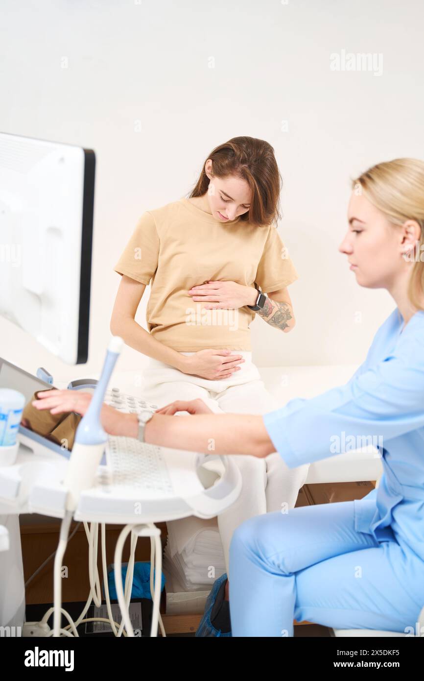 Gynecologist Prepare Ultrasound Machine For Scanning Of Pregnant Belly 