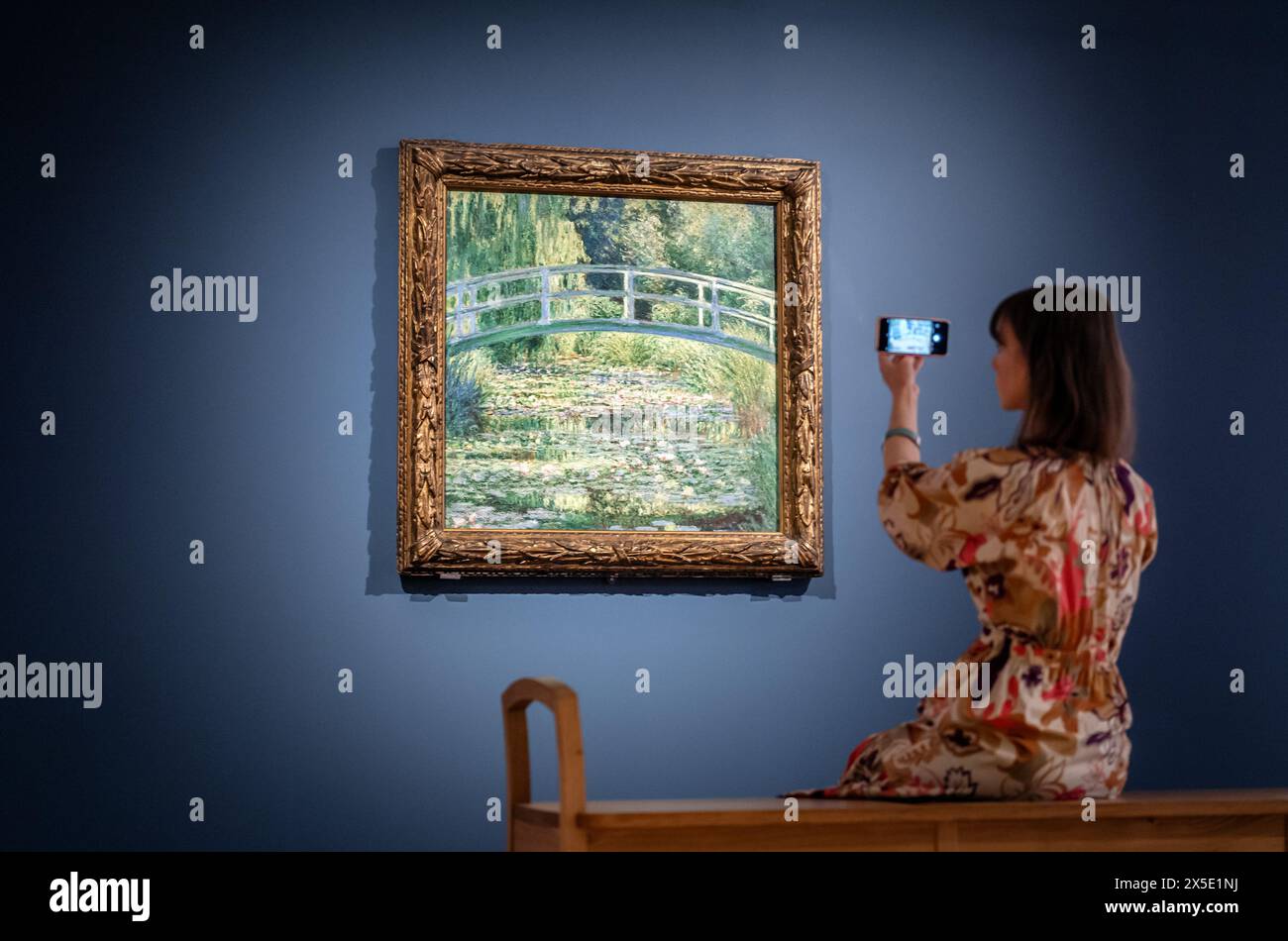 Dr Beatrice Bertram with Monet's 'The Water-Lily Pond' which will be the central feature of a major new exhibition at York Art Gallery to mark the 200th anniversary of the National Gallery. Picture date: Thursday May 9, 2024. Stock Photo