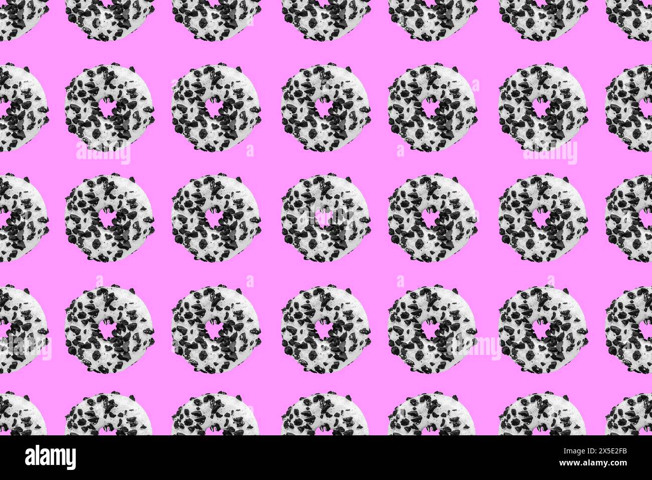 Pattern made with black and white cookie donut on pink background Stock Photo