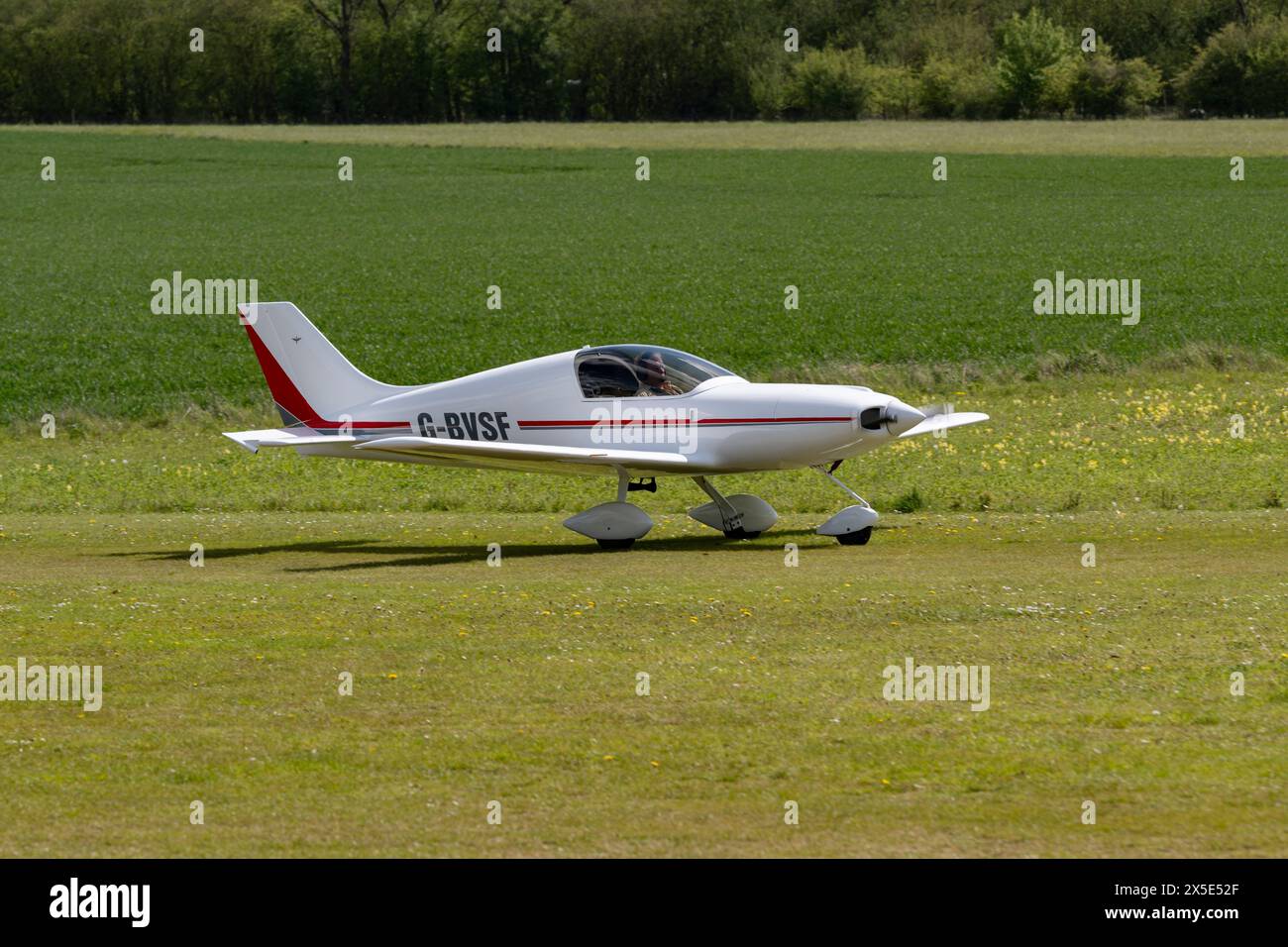 Very clean looking Aero Designs Pulsar Compsite Built Microlight Aircraft arrives at Popham airfield near Basingstoke in Hampshire for the Fly In Stock Photo