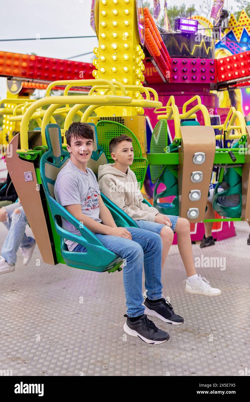 Happy children, enjoying a day in amusement park  with family Stock Photo