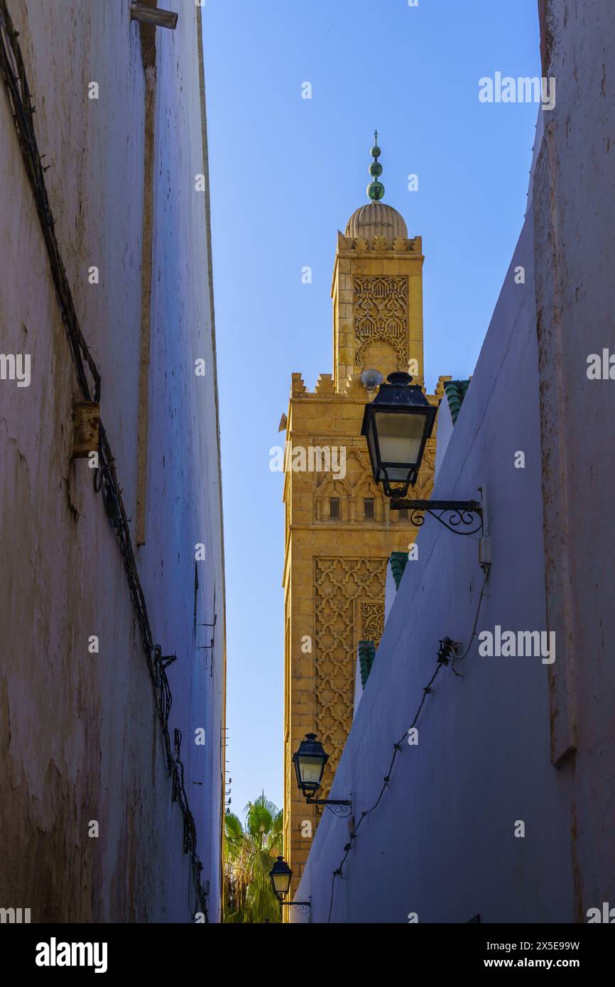 View of an alley and the Grand Mosque minaret, in the Old Medina of Casablanca, Morocco Stock Photo