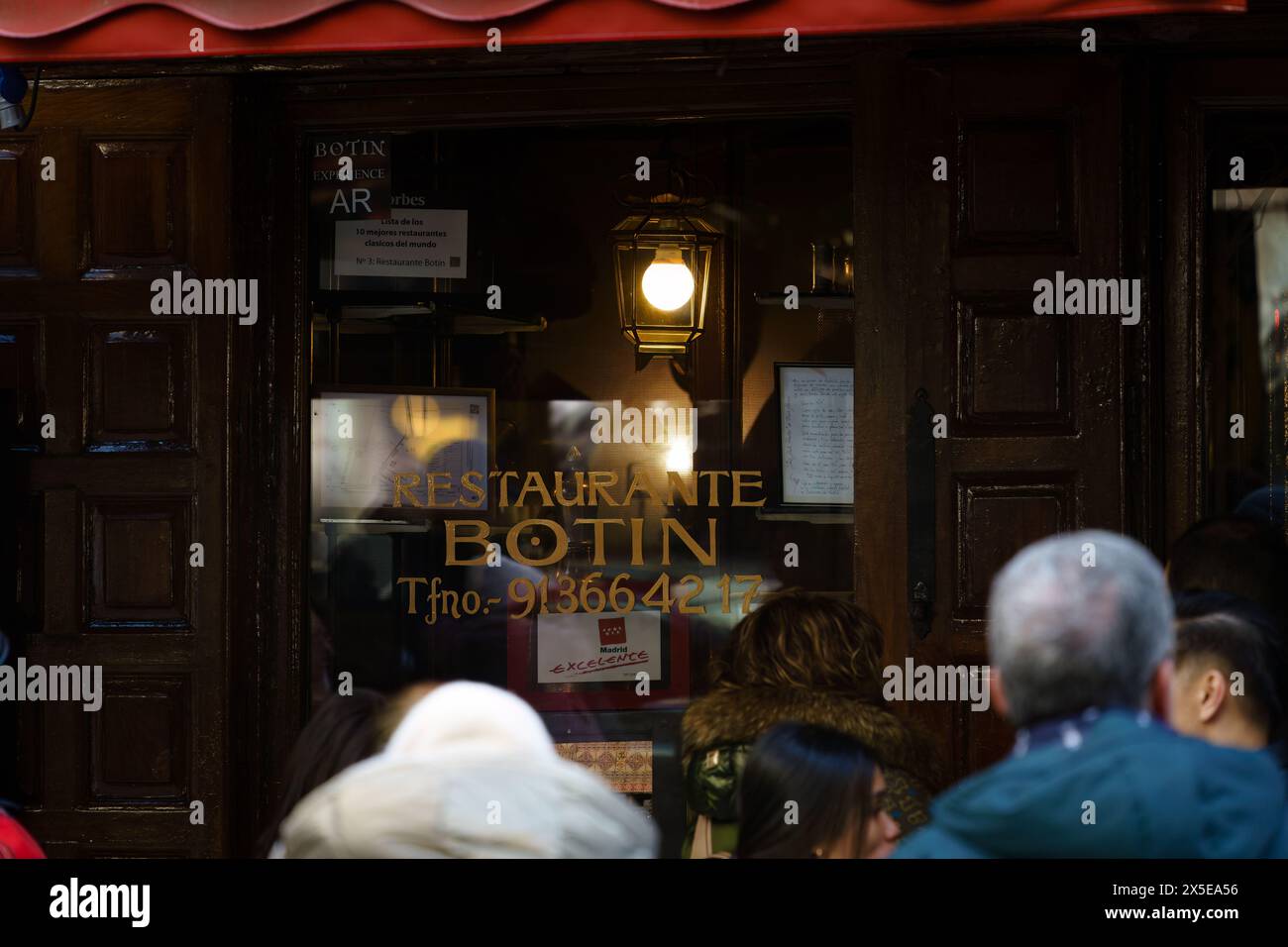 Madrid, Spain. February 11, 2024 - Group of People Standing Outside Restaurant Botin. Stock Photo
